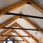 Glue Laminated Wood Beams Connected One Another with Steel Collar Ties Exposed for Raised A-frame Ceiling