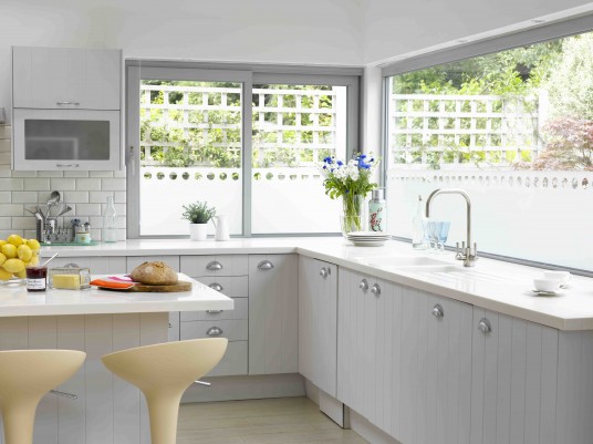 White Kitchen Design with Huge Windows Over Sink and Small Window In Other Side